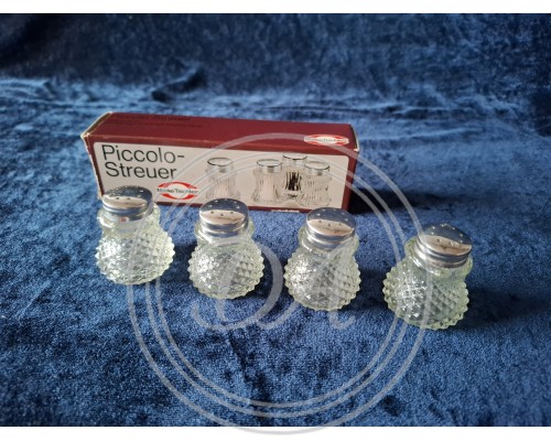 Set of vintage miniature salt and pepper shakers, elegant table setting.