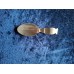 A collector's spoon with an unusually curved handle.