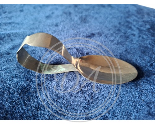 A collector's spoon with an unusually curved handle.