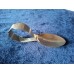 A collector's spoon with an unusually curved handle.