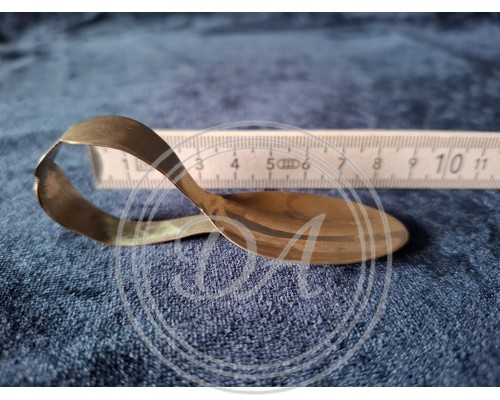 A collector's spoon with an unusually curved handle.