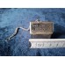 Stainless steel tea strainer and insert in the shape of a house.