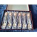 A set of 6 silver-plated teaspoons with a pink porcelain cameo flower inlay on the handle.