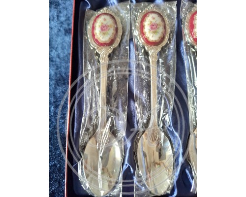 A set of 6 silver-plated teaspoons with a pink porcelain cameo flower inlay on the handle.