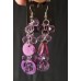 Purple drop earrings with crystals and mother-of-pearl or shell elements.