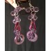 Purple drop earrings with crystals and mother-of-pearl or shell elements.