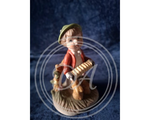 A porcelain figurine entitled "Boy with Accordion". 